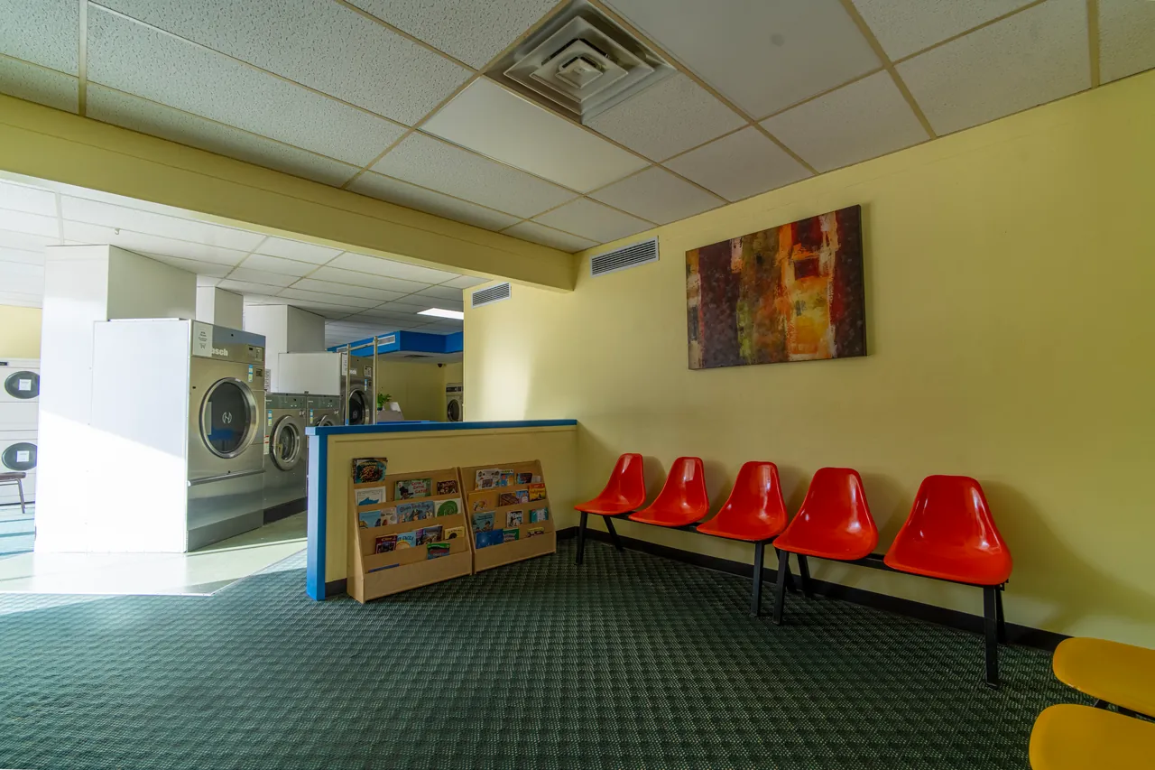 Customer seating area beside the laundromat machines